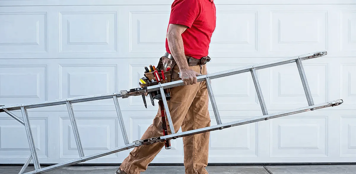 Garage door repair technician arriving with tools and ladder in New Haven, CT