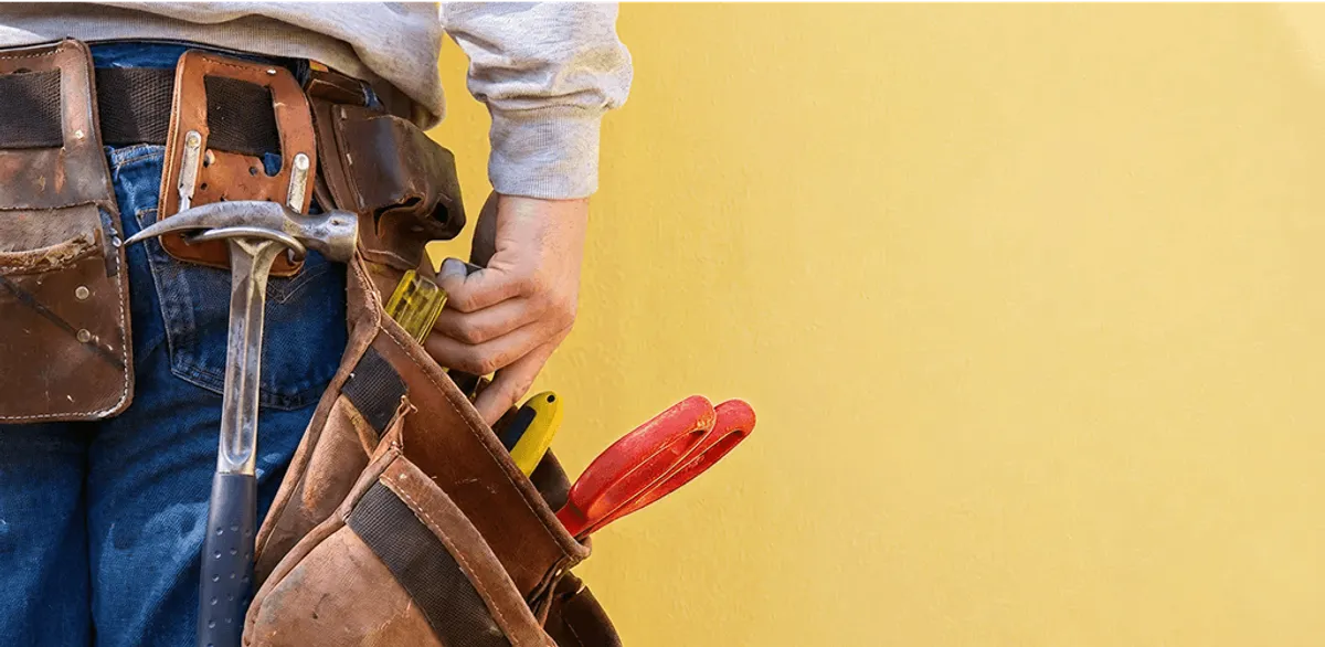 Handyman with tool belt ready for home repairs and maintenance in New Haven, CT
