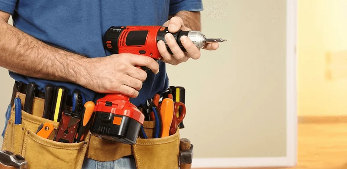 Handyman holding a power drill for home repairs and installations in New Haven, CT
